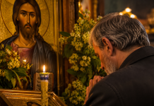 Credincios rugându-se în fața unei icoane în a doua zi de Rusalii